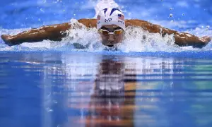 Swimmer Michael Phelps demonstrates how to swim butterfly stroke, powering through the water with a powerful dolphin kick and arm pull.