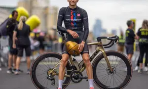 Alex Yee poses with his golden Trek bike, ready to race.