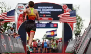A triathlete runs towards the finish line at the USA Triathlon Multisport National Championships Festival, a testament to their USA Triathlon membership.
