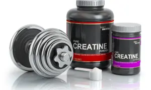 Dumbbells and containers of creatine powder and capsules, ideal for swimmers looking to boost their performance.