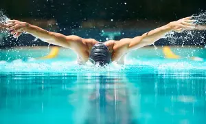 Swimmer performing butterfly stroke, showcasing the power and fluidity needed for mobility exercises for swimmers.