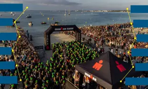 Ironman swim start line with athletes in green caps. The 70.3 vineman race is about to begin by the sea.