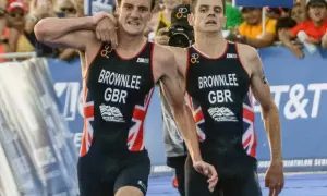 The Brownlee brothers, Alistair and Jonny, in their Great Britain triathlon kits, exhausted but together after a race.