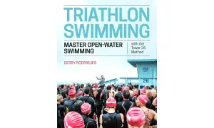 Cover of "Triathlon Swimming" book, featuring a group of swimmers in wetsuits preparing for an open-water event.