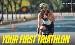 A smiling man on a bike gives a shaka sign, ready for his first triathlon. He's a perfect example of triathlon newbies embracing the challenge.