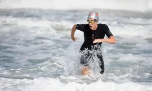 Lucy Charles Barclay emerges from the ocean, a powerful stride through the waves.