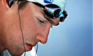 Michael Phelps in deep visualization, wearing Speedo cap and goggles, preparing for a race.