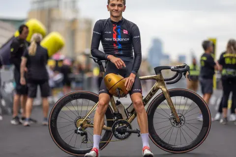 Alex Yee poses with his golden Trek bike, ready to race.