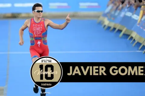 Javier Gomez, one of the greatest triathletes of all time, runs with his finger pointed up.