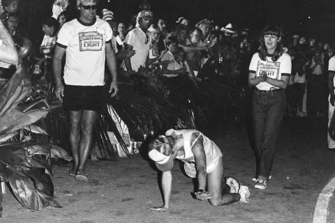 Julie Moss crawling during the 1982 Ironman, a moment of incredible perseverance.