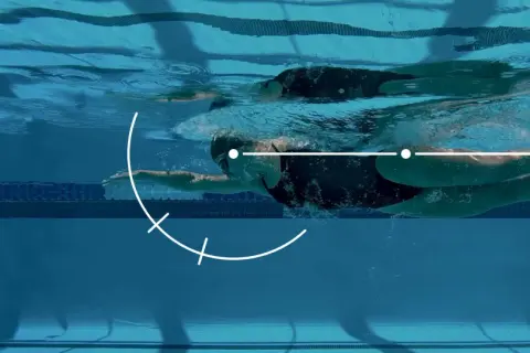 Underwater view of a swimmer executing a freestyle stroke, with graphic overlays illustrating key movement points for freestyle tips.