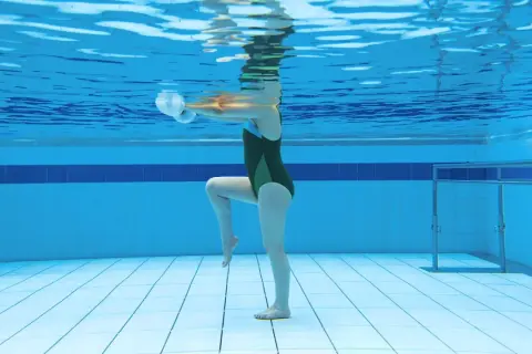 Underwater view of a person doing aquatic exercise with weights, showcasing the running in water benefits for a low-impact workout.