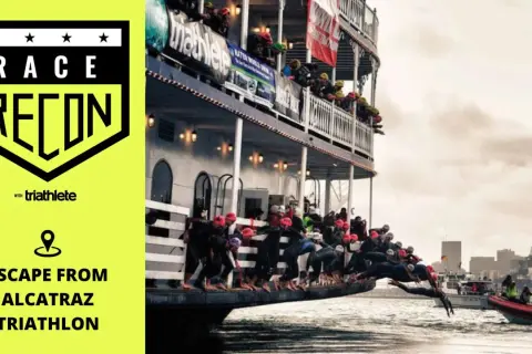 Athletes dive from a boat into the water for the Escape from Alcatraz Triathlon.