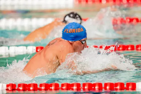 Ryan Lochte, wearing a blue "Florida" cap, powers through the water during intense swim workouts.