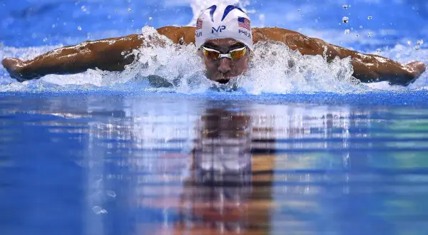 Swimmer Michael Phelps demonstrates how to swim butterfly stroke, powering through the water with a powerful dolphin kick and arm pull.