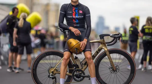 Alex Yee poses with his golden Trek bike, ready to race.