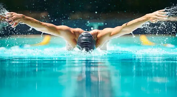 Swimmer performing butterfly stroke, showcasing the power and fluidity needed for mobility exercises for swimmers.