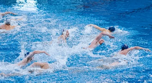 Intense water polo periods with athletes battling for the ball amidst splashing water.
