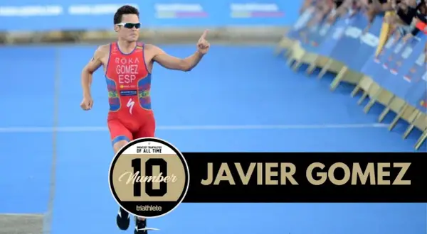 Javier Gomez, one of the greatest triathletes of all time, runs with his finger pointed up.