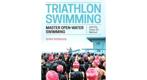 Cover of "Triathlon Swimming" book, featuring a group of swimmers in wetsuits preparing for an open-water event.