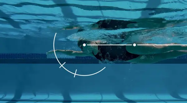 Underwater view of a swimmer executing a freestyle stroke, with graphic overlays illustrating key movement points for freestyle tips.