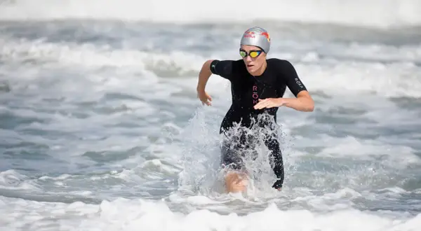 Lucy Charles Barclay emerges from the ocean, a powerful stride through the waves.