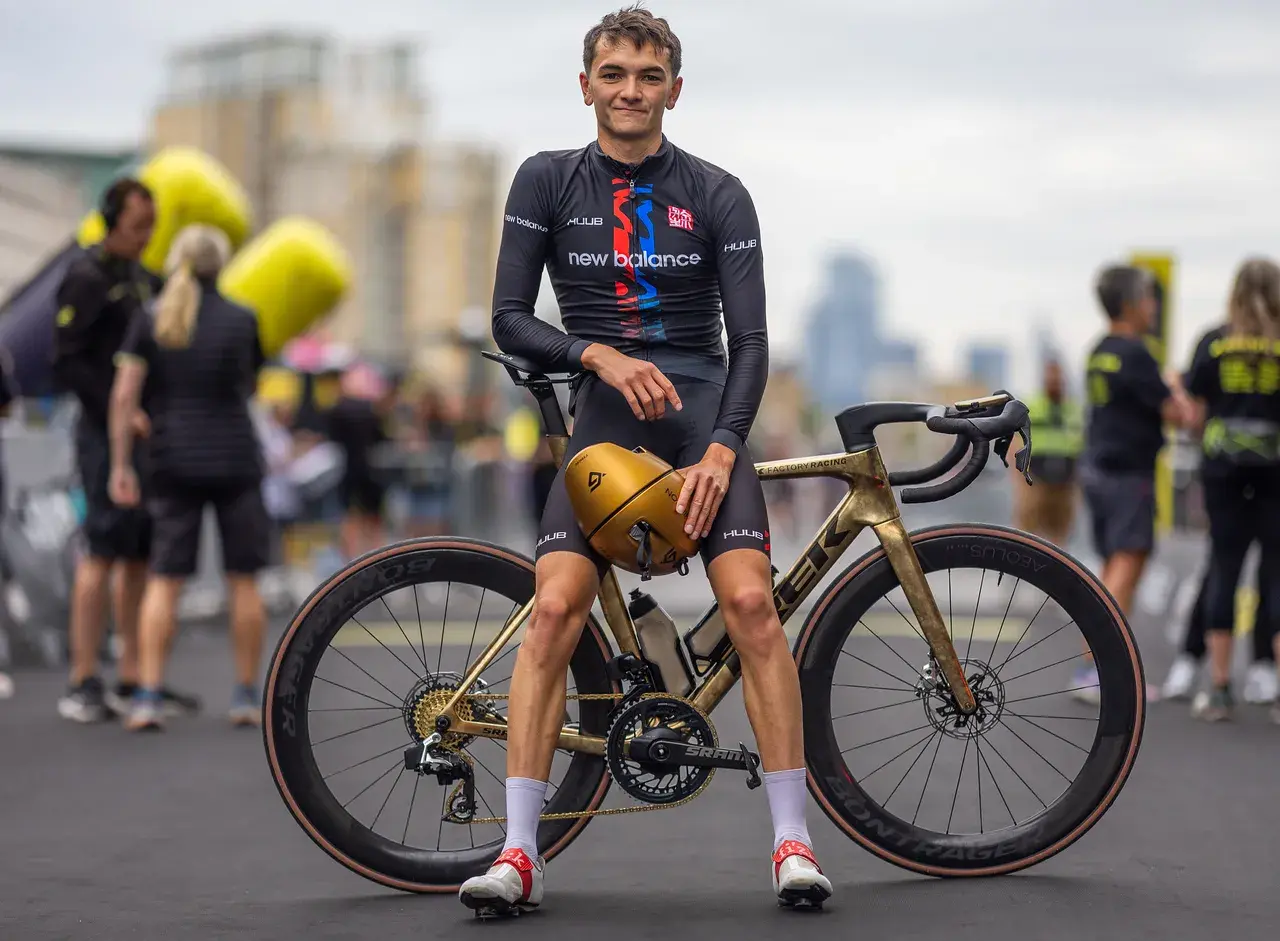Alex Yee poses with his golden Trek bike, ready to race.