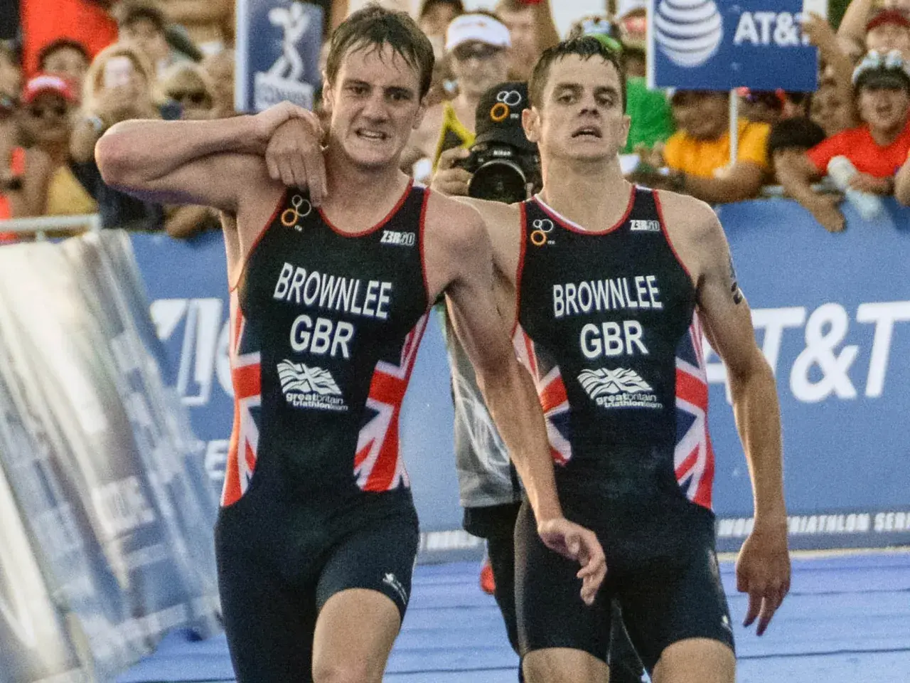 The Brownlee brothers, Alistair and Jonny, in their Great Britain triathlon kits, exhausted but together after a race.