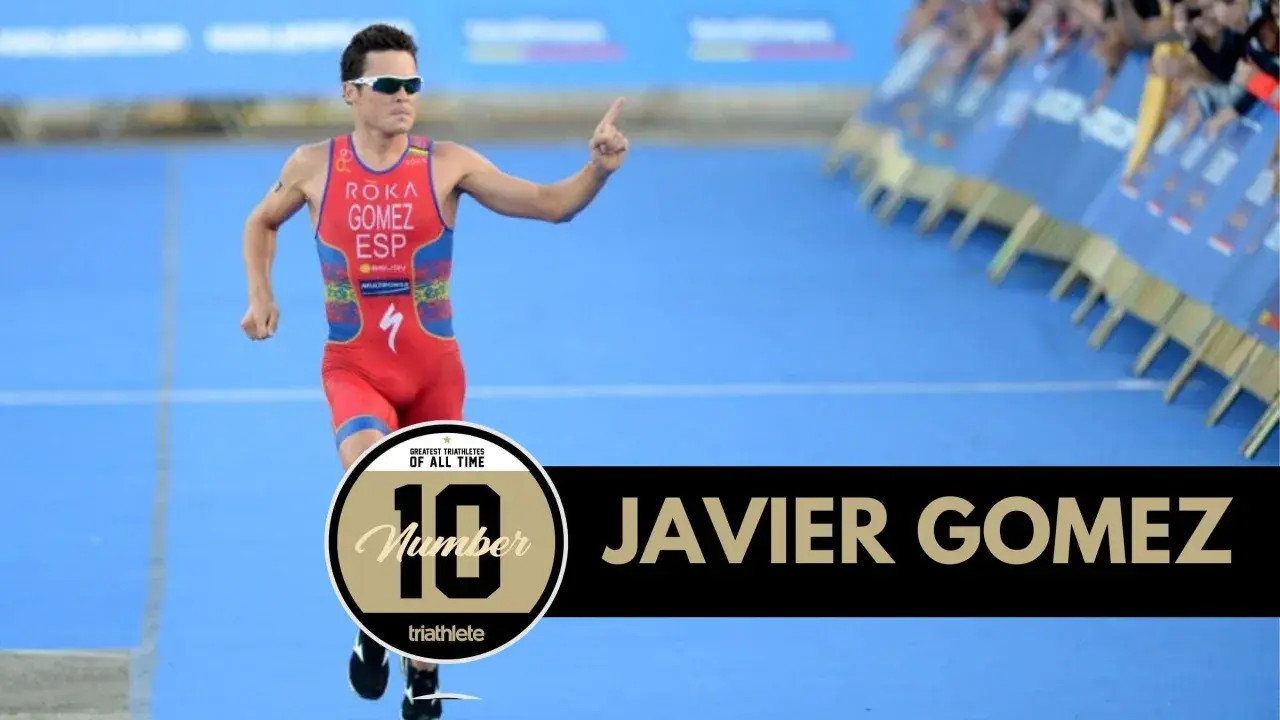Javier Gomez, one of the greatest triathletes of all time, runs with his finger pointed up.