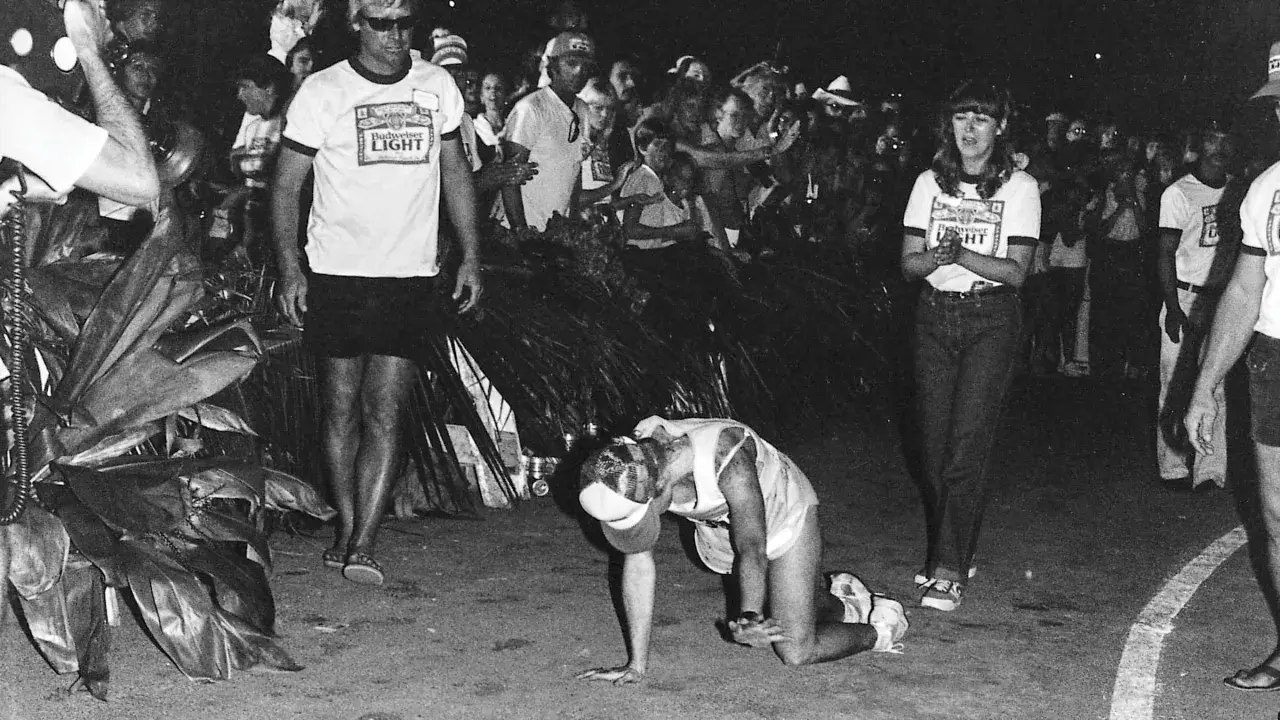 Julie Moss crawling during the 1982 Ironman, a moment of incredible perseverance.