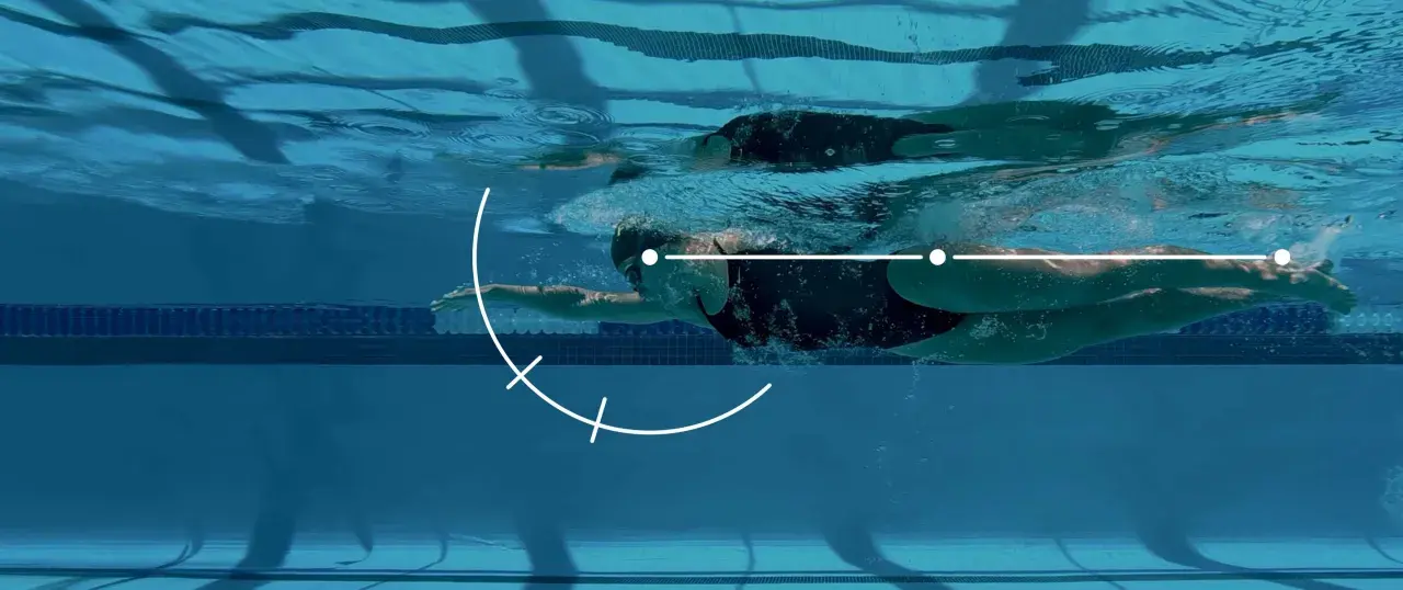 Underwater view of a swimmer executing a freestyle stroke, with graphic overlays illustrating key movement points for freestyle tips.