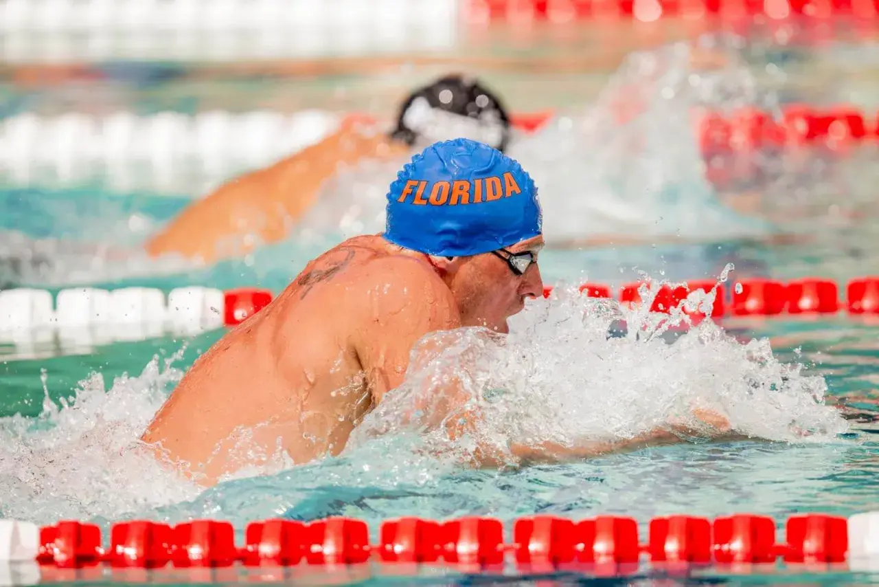 Ryan Lochte, wearing a blue "Florida" cap, powers through the water during intense swim workouts.