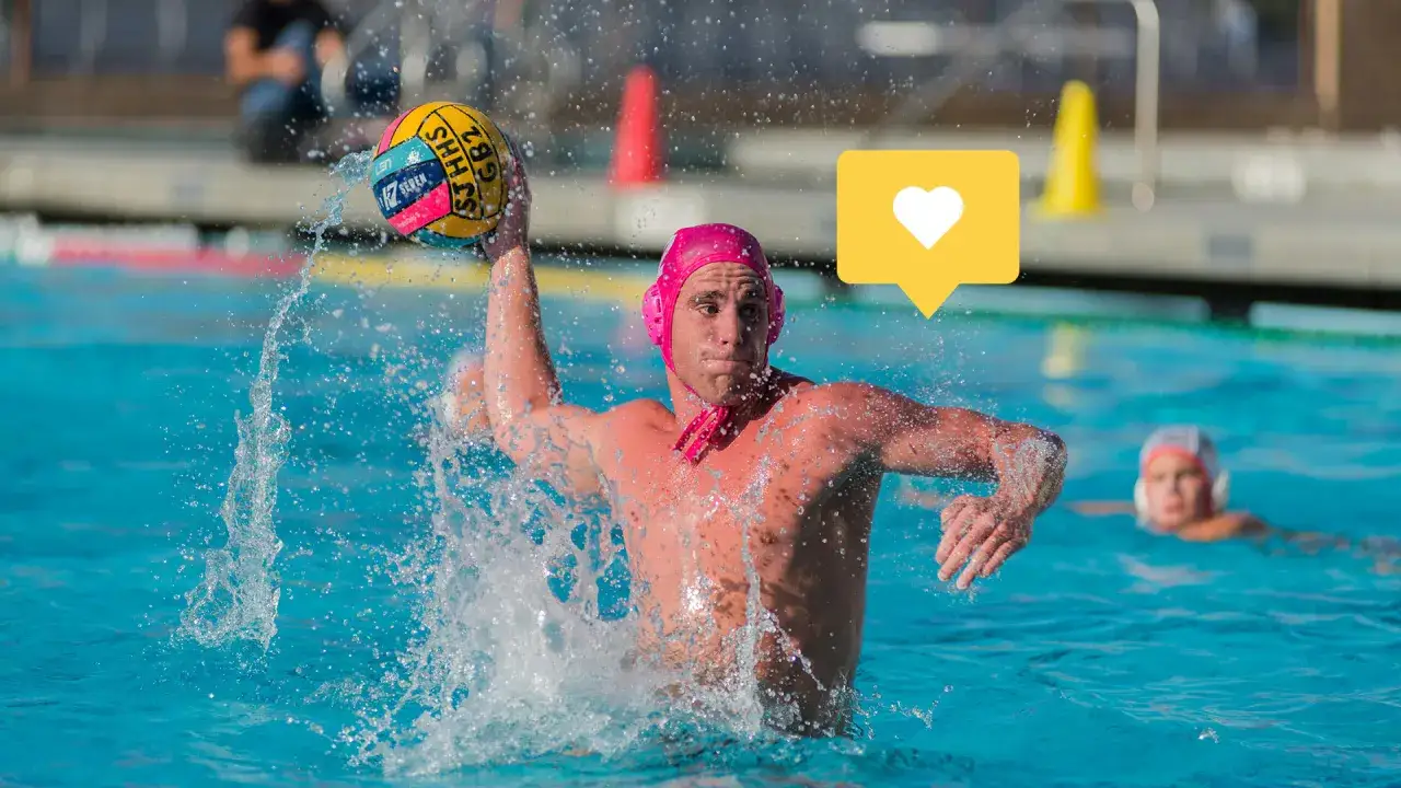 A water polo player in a pink cap throws the ball, splashing water. This is a great example of exciting underwater games.