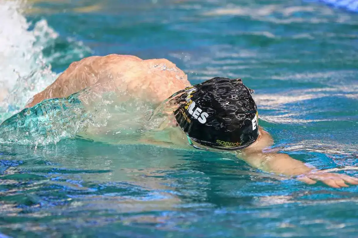 Swimmer in black cap with