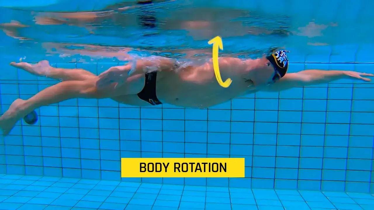 Swimmer demonstrating body rotation, a key element for efficient freestyle swimming. Learn these freestyle tips for better performance.