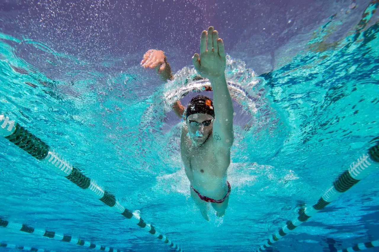 Underwater shot of a swimmer performing a freestyle stroke, demonstrating the power and control needed for effective core workouts for swimmers.