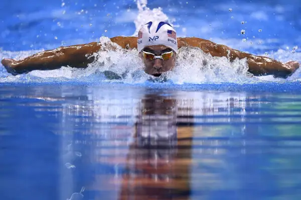 Swimmer Michael Phelps demonstrates how to swim butterfly stroke, powering through the water with a powerful dolphin kick and arm pull.
