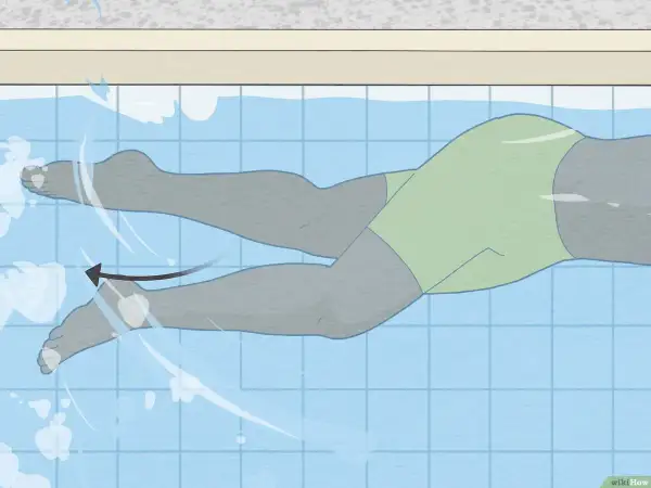 Illustration of a swimmer's legs demonstrating the freestyle kick technique. The legs are in a flutter motion, propelling the swimmer forward.