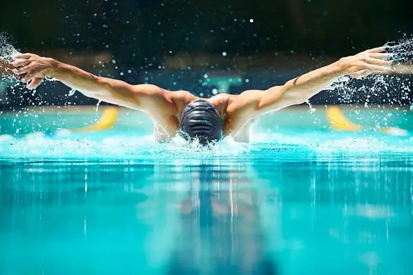 Swimmer performing butterfly stroke, showcasing the power and fluidity needed for mobility exercises for swimmers.