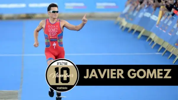 Javier Gomez, one of the greatest triathletes of all time, runs with his finger pointed up.