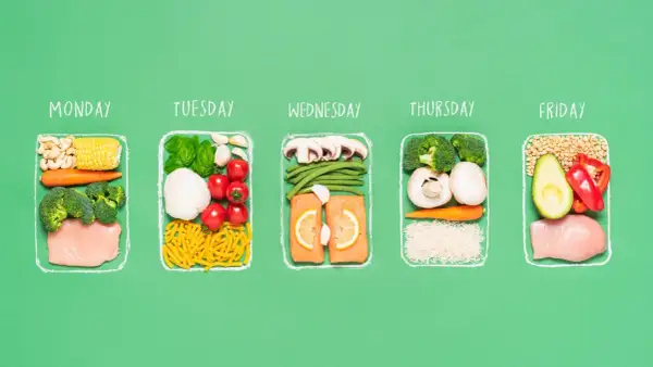 A week's worth of healthy meals for a half ironman nutrition plan, featuring chicken, salmon, vegetables, and grains for each day.