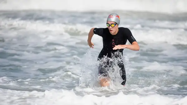 Lucy Charles Barclay emerges from the ocean, a powerful stride through the waves.